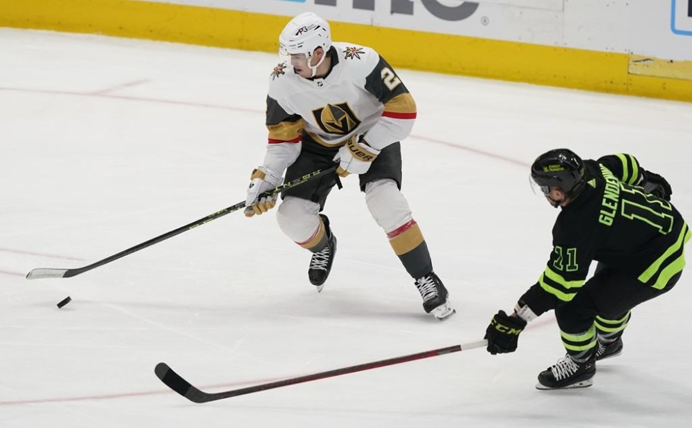 Vegas Golden Knights defenceman Zach Whitecloud (2) skates with the puck as Dallas Stars center Luke Glendening (11) moves in during the first period of an NHL hockey game in Dallas, Saturday, April 8, 2023. Members from Sioux Valley Dakota Nation in southwestern Manitoba donned Vegas Golden Knights jerseys as they watched the team battle the Winnipeg Jets during the series-opener Tuesday evening with all eyes on Whitecloud. THE CANADIAN PRESS/AP-LM Otero