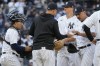 New York Yankees manager Aaron Boone, second from left, removes pitcher Nestor Cortes, left, in the seventh inning of a baseball game against the Los Angeles Angels, Thursday, April 20, 2023, in New York. (AP Photo/Mary Altaffer)