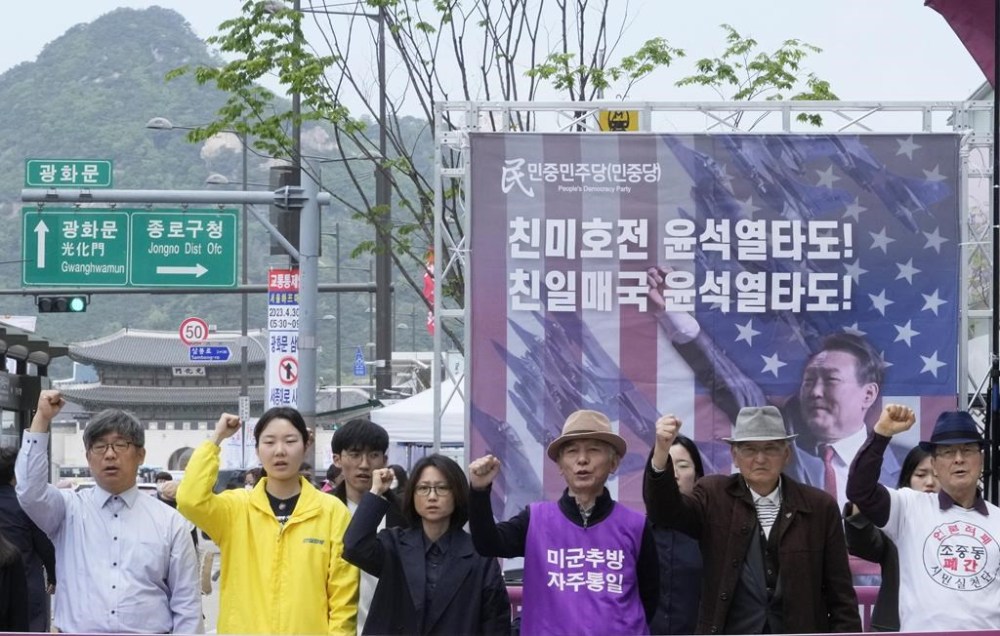 Protesters with a banner showing an image of South Korean President Yoon Suk Yeol stage a rally to denounce policies of the United States and South Korea on North Korea near the U.S. Embassy in Seoul, South Korea, Friday, April 21, 2023. North Korea's foreign minister on Friday called the Group of Seven wealthy democracies a