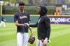 Cleveland Guardians starting pitcher Triston McKenzie, left, shakes hands with Miami Marlins center fielder Jazz Chisholm Jr. before a baseball game, Friday, April 21, 2023, in Cleveland. (AP Photo/Nick Cammett)