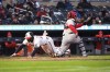 Minnesota Twin's' Ryan Jeffers, left, slides past Washington Nationals catcher Keibert Ruiz to score during the third inning of a baseball game Friday, April 21, 2023, in Minneapolis. (AP Photo/Craig Lassig)