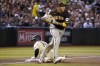 San Diego Padres third baseman Manny Machado bobbles the ball as Arizona Diamondbacks' Gabriel Moreno slides safely into third, advancing on a hit by Geraldo Perdomo during the third inning of a baseball game Friday, April 21, 2023, in Phoenix. (AP Photo/Darryl Webb)