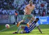 Bremen's Mitchell Weiser, top, and Hertha's Tolga Cigerci fight for the ball during the Bundesliga soccer match between Hertha BSC and Werder Bremen at Olympiastadion, in Berlin, Saturday, April 22, 2023. (Soeren Stache/dpa via AP)
