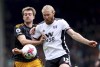 Leeds United's Patrick Bamford, left, and Fulham's Tim Ream battle for the ball during the English Premier League soccer match between Fulham and Leeds United at Craven Cottage, London, Saturday April 22, 2023. (Steven Paston/PA via AP)
