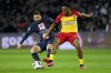 PSG's Lionel Messi, left, and Lens' Lois Openda fight for the ball during the French League One soccer match between Paris Saint Germain and Lens at Parc des Princes stadium in Paris, France, Saturday, April 15, 2023. (AP Photo/Michel Euler)