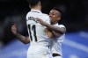 Real Madrid's Eder Militao, right, celebrates with Marco Asensio after scoring his side's second goal during the Spanish La Liga soccer match between Real Madrid and Celta Vigo at the Santiago Bernabeu stadium in Madrid, Spain, Saturday, April 22, 2023. (AP Photo/Manu Fernandez)