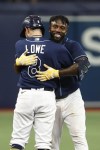 Tampa Bay Rays' Randy Arozarena celebrates with teammate Brandon Lowe after hitting the game winning RBI single against the Chicago White Sox during the 10th inning of a baseball game Saturday, April 22, 2023, in St. Petersburg, Fla. (AP Photo/Scott Audette)