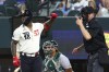 Texas Rangers right fielder Adolis Garcia (53) reacts after being hit by a pitch in the second inning by Oakland Athletics starting pitcher Shintaro Fujinami during a baseball game on Saturday, April 22, 2023, in Arlington, Texas. (AP Photo/Richard W. Rodriguez)