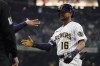 Milwaukee Brewers' Blake Perkins is congratulated by first base coach Quintin Berry during the fifth inning of the team's baseball game against the Boston Red Sox on Saturday, April 22, 2023, in Milwaukee. It was the first hit for Perkins in the majors. (AP Photo/Aaron Gash)