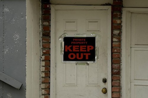 FILE - A keep out sign is posted on a home, Wednesday, April 19, 2023, near the house where 84-year-old Andrew Lester shot 16-year-old Ralph Yarl a week earlier in Kansas City, Mo. (AP Photo/Charlie Riedel, File)