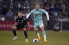 St. Louis City forward Klauss, front, pursues the ball as Colorado Rapids defender Danny Wilson watches during the first half of an MLS soccer match Saturday, April 22, 2023, in Commerce City, Colo. (AP Photo/David Zalubowski)