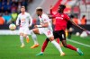 Leverkusen's Odilon Kossounou, right, and Leipzig's Benjamin Henrichs battle for the ball during the Bundesliga soccer match between Bayer Leverkusen and RB Leipzig at BayArena, Leverkusen, Germany, Sunday April 23, 2023. (Marius Becker/dpa via AP)