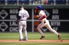 Philadelphia Phillies' Trea Turner, right, rounds the bases past Colorado Rockies first baseman C.J. Cron after hitting a home run during the first inning of a baseball game, Sunday, April 23, 2023, in Philadelphia. (AP Photo/Matt Slocum)