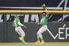 Oakland Athletics center fielder Esteury Ruiz (1) catches the sacrifice fly in front of Tony Kemp hit by Texas Rangers' Robbie Grossman during the fourth inning of a baseball game, Sunday, April 23, 2023, in Arlington, Texas. (AP Photo/Jim Cowsert)