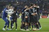 Marseille players celebrate after Lyon's Malo Gusto scored an own goal during the French League One soccer match between Lyon and Marseille at the Groupama stadium, in Decines, near Lyon, France, Sunday, April 23, 2023. (AP Photo/Laurent Cipriani)