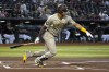 San Diego Padres' Juan Soto hits a single against the Arizona Diamondbacks in the first inning during a baseball game, Sunday, April 23, 2023, in Phoenix. (AP Photo/Rick Scuteri)