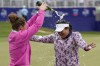 Lilia Vu, right, celebrates on the 18th green with Anne-Lise Bidou after winning in a playoff against Angel Yin in the Chevron Championship women's golf tournament at The Club at Carlton Woods on Sunday, April 23, 2023, in The Woodlands, Texas. (AP Photo/Eric Gay)
