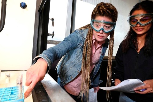 Candace Ronhaar, left, an instructor, teaches Crystal Baker how to use red cabbage, a natural pH indicator, to test the pH of different substances during Chemistry 121 class at Everett Community College on Friday, March 10, 2023. Students who need extra help in subjects struggle to learn if the content is taught in an abstract, isolated manner, educators say. That’s why I-BEST programs feature two teachers in the classroom: one provides job training and the other teaches basic skills in reading, math or English language. (Karen Ducey/The Seattle Times via AP)