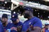 Houston Astros left fielder Yordan Alvarez, right, and hitting coach Alex Cintron (37) laugh before the team's baseball game against the Atlanta Braves, Saturday, April 22, 2023, in Atlanta. (AP Photo/Brynn Anderson)