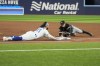 Toronto Blue Jays shortstop Bo Bichette (11) slides into first base as Chicago White Sox first baseman Andrew Vaughn (25) reaches during the third inning American League MLB baseball action in Toronto on Monday, April 24, 2023. THE CANADIAN PRESS/Andrew Lahodynskyj
