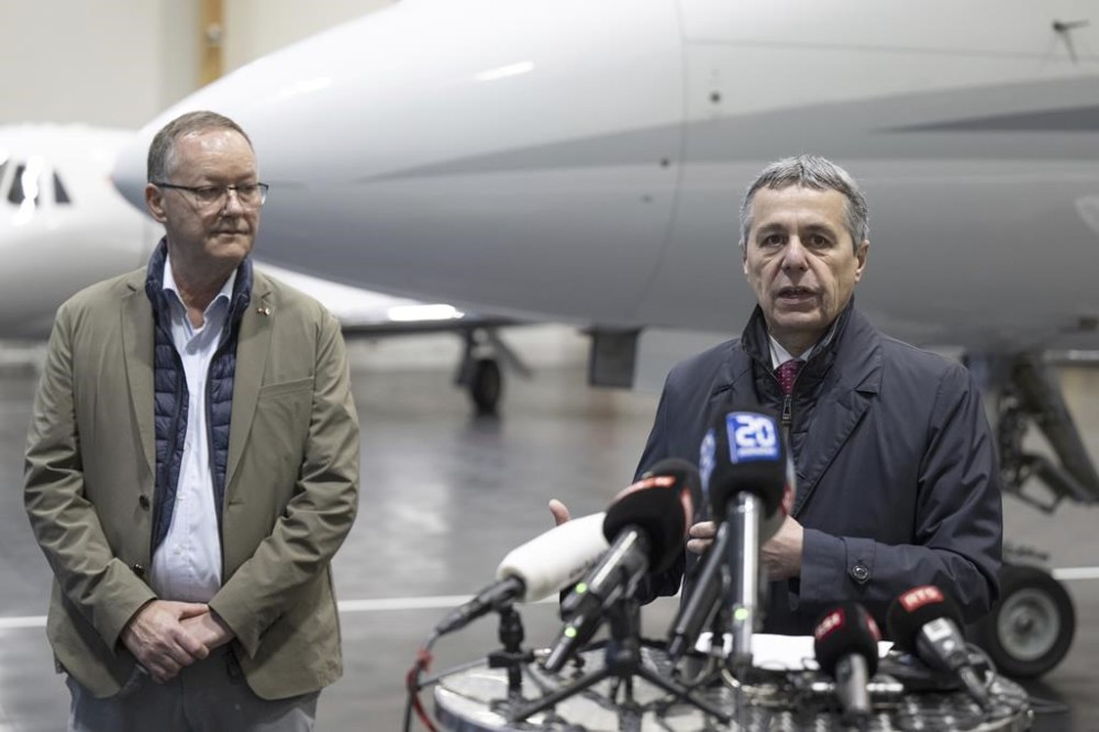 Swiss Federal Councilor Ignazio Cassis, right, with Christian Winter, left, Swiss Ambassador of Sudan, speaks during a press conference at the Bern-Belp Airport in Belp, Switzerland, Tuesday, April 25, 2023. Swiss nationals are flown out of the crisis area in Sudan. (Peter Schneider/Keystone via AP, Pool)