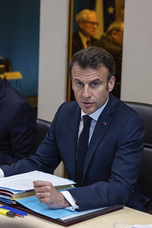 French President Emmanuel Macron chairs a defense council concerning the crisis in Sudan at the Elysee Palace in Paris, Tuesday, April 25, 2023. Hundreds of foreign nationals have been safely evacuated from Sudan where continued fighting threatens to plunge the African country deeper into chaos. Officials say France has evacuated 491 people, including citizens from 36 countries, on flights to Djibouti in the nearby Horn of Africa. (Christophe Petit Tesson, Pool via AP)