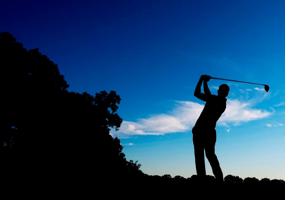 A golfer is silhouetted in Oakville, Ont., on Friday, July 26, 2013. The PGA Tour is merging two of its third-tier circuits. PGA Tour Canada and PGA Tour Latinoamérica will combine to become the PGA Tour Americas in February. THE CANADIAN PRESS/Nathan Denette
