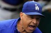 Los Angeles Dodgers manager Dave Roberts stands in the dugout before the team's baseball game against the Pittsburgh Pirates in Pittsburgh, Tuesday, April 25, 2023. (AP Photo/Gene J. Puskar)