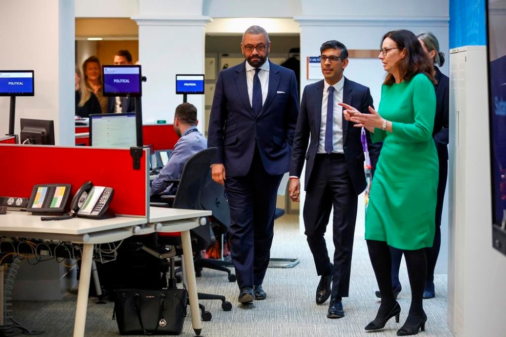 British Prime Minister Rishi Sunak and Foreign Secretary James Cleverly, left, meet with teams coordinating the evacuation of British nationals from Sudan, at the FCDO Crisis Centre, in London, Tuesday April 25, 2023. (Hannah McKay/Pool via AP)