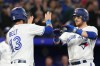 Toronto Blue Jays' Danny Jansen (right) celebrates with Brandon Belt after hitting a three-run home run off Chicago White Sox starting pitcher Mike Clevinger during second inning American League MLB baseball action in Toronto on Tuesday, April 25 2023.THE CANADIAN PRESS/Chris Young
