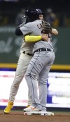 Milwaukee Brewers' Willy Adames (27) and Detroit Tigers' Miguel Cabrera greet one another during the third inning of a baseball game Tuesday, April 25, 2023, in Milwaukee. (AP Photo/Jeffrey Phelps)