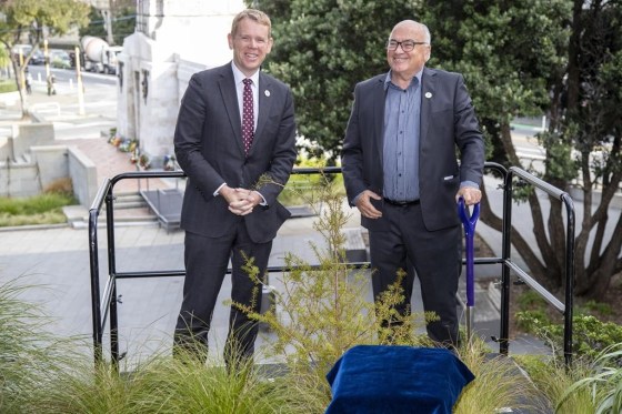 New Zealand Prime Minister Chris Hipkins, left, and and Project Crimson chairman Joris De Bres pose after planting a totara tree in Wellington, Wednesday. (Mark Mitchell / New Zealand Herald / The Associated Press)