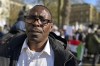 Attorney Abobaker Adam stands outside Britain's Ministry of Defense in London during a demonstration calling for the end of fighting in Sudan on Sunday, April 23, 2023. Sudanese emigrants living in the United Kingdom are worried about loved ones living in a battle zone back home and doing whatever they can to help in the dire situation.(AP Photo/Brian Melley)