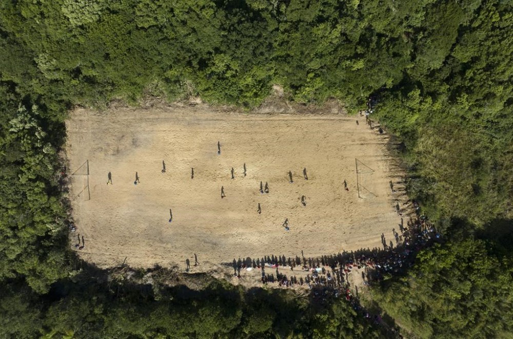Indigenous athletes compete in a soccer match as part of the Indigenous Games, in the Tapirema community of Peruibe, Brazil, Saturday, April 22, 2023. Hundreds of Indigenous athletes gather this weekend in the south of Sao Paulo state to hold their version of the Olympic Games. They will compete for medals in archery, tug of war, athletics, Indigenous wrestling and other sports. (AP Photo/Andre Penner)
