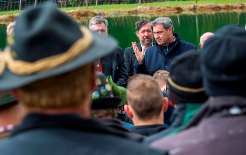 Bavaria's governor Markus Soeder gestures as he attends a farmers meeting in Oberaudorf, Germany, Wednesday, April 26, 2023 because of the sheep ripping by a bear in the mountain region near the border. Officials in Germany’s southern state of Bavaria said Wednesday that they want to make it easier to shoot wolves after farmers complained that their livestock on Alpine pastures are being preyed upon. (Peter Kneffel/dpa via AP)