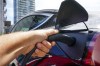 An electric vehicle is charged in Ottawa on Wednesday, July 13, 2022.&nbsp;Electric vehicle drivers can expect more charging options ahead as the Canada Infrastrcture Bank is loaning $220 million to Flo Services Inc. to expand its network. THE CANADIAN PRESS/Sean Kilpatrick