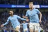 Manchester City's Kevin De Bruyne celebrates with Manchester City's Bernardo Silva, left, after scoring the opening goal during the English Premier League soccer match between Manchester City and Arsenal at Etihad stadium in Manchester, England, Wednesday, April 26, 2023. (AP Photo/Dave Thompson)