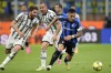 Inter Milan's Lautaro Martinez, right, and Juventus' Manuel Locatelli challenge for the ball during a Italian cup semi final second leg soccer match between Inter Milan and Juventus at the San Siro stadium in Milan, Italy, Wednesday, April 26, 2023. (AP Photo/Luca Bruno)