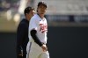 Minnesota Twins starting pitcher Kenta Maeda, front, leaves the game with his translator and team trainer (not pictured) during the fourth inning of a baseball game against the New York Yankees, Wednesday, April 26, 2023, in Minneapolis. (AP Photo/Abbie Parr)