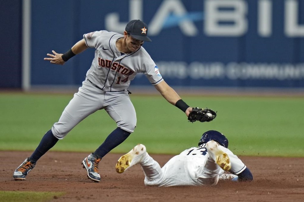 Houston Astros second baseman Mauricio Dubon (14) catches Tampa Bay Rays' Manuel Margot attempting to steal second base during the third inning of a baseball game Wednesday, April 26, 2023, in St. Petersburg, Fla. (AP Photo/Chris O'Meara)