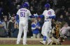 Chicago Cubs' Eric Hosmer, left, high-fives Chicago Cubs' Trey Mancini after he hit a home run during the fourth inning of a baseball game against the San Diego Padres Wednesday, April 26, 2023, in Chicago. (AP Photo/Erin Hooley)