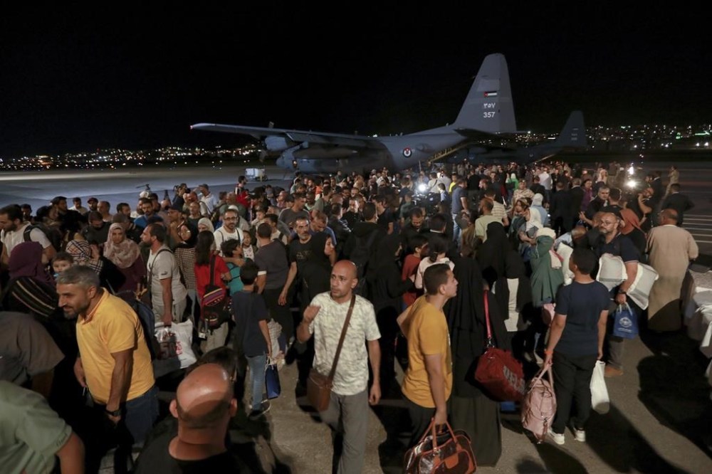 FILE - Jordanians evacuated from Sudan arrive at a military airport in Amman, Jordan, Monday, April 24, 2023. Warring factions trying to seize control of the east African nation of Sudan have plunged the country into chaos, and thousands are fleeing the capital of Khartoum and nearby battle zones. Some countries, including the U.S., have shuttered their embassies and many are coordinating daring evacuations of their staffs and other residents in an array of convoys, flights and frantic getaway drives. (AP Photo/Raad Adayleh, File)