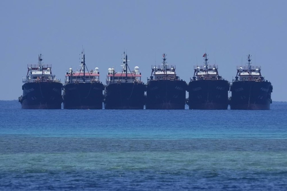 Some of the many suspected Chinese militia ships lay side by side at the Philippine-claimed reef called Whitsun, locally known as Julian Felipe reef, at the South China Sea, on Saturday, April 22, 2023. A Chinese coast guard ship blocked a Philippine patrol vessel steaming into a disputed shoal in the South China Sea in the latest act of Beijing's aggression in the strategic waterway that led to a frightening near-collision witnessed by journalists. (AP Photo/Aaron Favila)