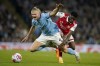 Arsenal's Thomas Partey, right, fights for the ball with Manchester City's Erling Haaland during the English Premier League soccer match between Manchester City and Arsenal at Etihad stadium in Manchester, England, Wednesday, April 26, 2023. (AP Photo/Dave Thompson)