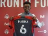 Newly acquired centre back Aime Mabika is shown displaying his Toronto FC jersey at the MLS club's training facility on Thursday April 27, 2023. Mabika came over in a trade with Inter Miami CF. THE CANADIAN PRESS/Neil Davidson