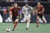 Atlanta United midfielder Matheus Rossetto, left, drives down field past Toronto FC midfielder Jonathan Osorio, centre, during the second half of an MLS soccer match, Saturday, March 4, 2023, in Atlanta. Osorio is the latest Toronto FC player hit by the injury bug. THE CANADIAN PRESS/AP/Alex Slitz