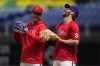 Philadelphia Phillies' Bryson Stott, left, and Bryce Harper laugh before a baseball game against the Colorado Rockies, Saturday, April 22, 2023, in Philadelphia. (AP Photo/Matt Slocum)