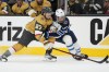 Vegas Golden Knights defenceman Shea Theodore (27) and Winnipeg Jets forward Morgan Barron (36) vie for the puck during the third period of Game 1 of an NHL hockey Stanley Cup first-round playoff series Tuesday, April 18, 2023, in Las Vegas. Jets forward Morgan Barron will go back to his regular visor starting Thursday night after using a full cage on his helmet for most of Winnipeg's first-round series against the Vegas Golden Knights.THE CANADIAN PRESS/AP, John Locher