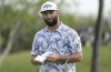 Jon Rahm, of Spain, checks his score card at the 13th green during the Mexico Open golf tournament's first round in Puerto Vallarta, Mexico, Thursday, April 27, 2023. (AP Photo/Moises Castillo)