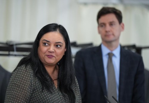 B.C. Nurses' Union President Aman Grewal speaks as B.C. Premier David Eby, back right, listens during an announcement at Langara College in Vancouver, on January 9, 2023. THE CANADIAN PRESS/Darryl Dyck